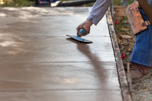 Newly installed reinforced concrete driveway with smooth finish at a residential property