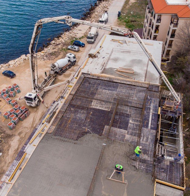 Concrete placement crew leveling and finishing a slab installation