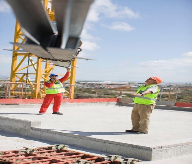 Commercial concrete crew pouring and finishing reinforced concrete slab at a construction site in Frisco, TX