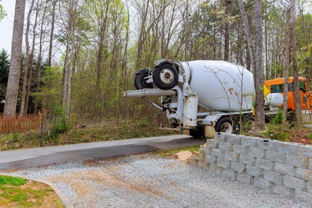 Concrete contractor installing and finishing reinforced residential driveway at a property in Frisco, TX