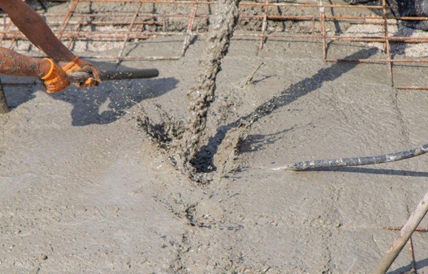 Concrete placement crew leveling and finishing a slab installation